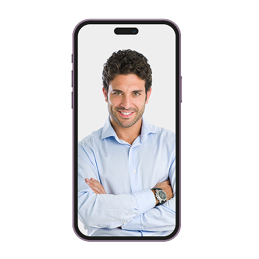 An older man in a hat holding a small white dog inside a phone screen.